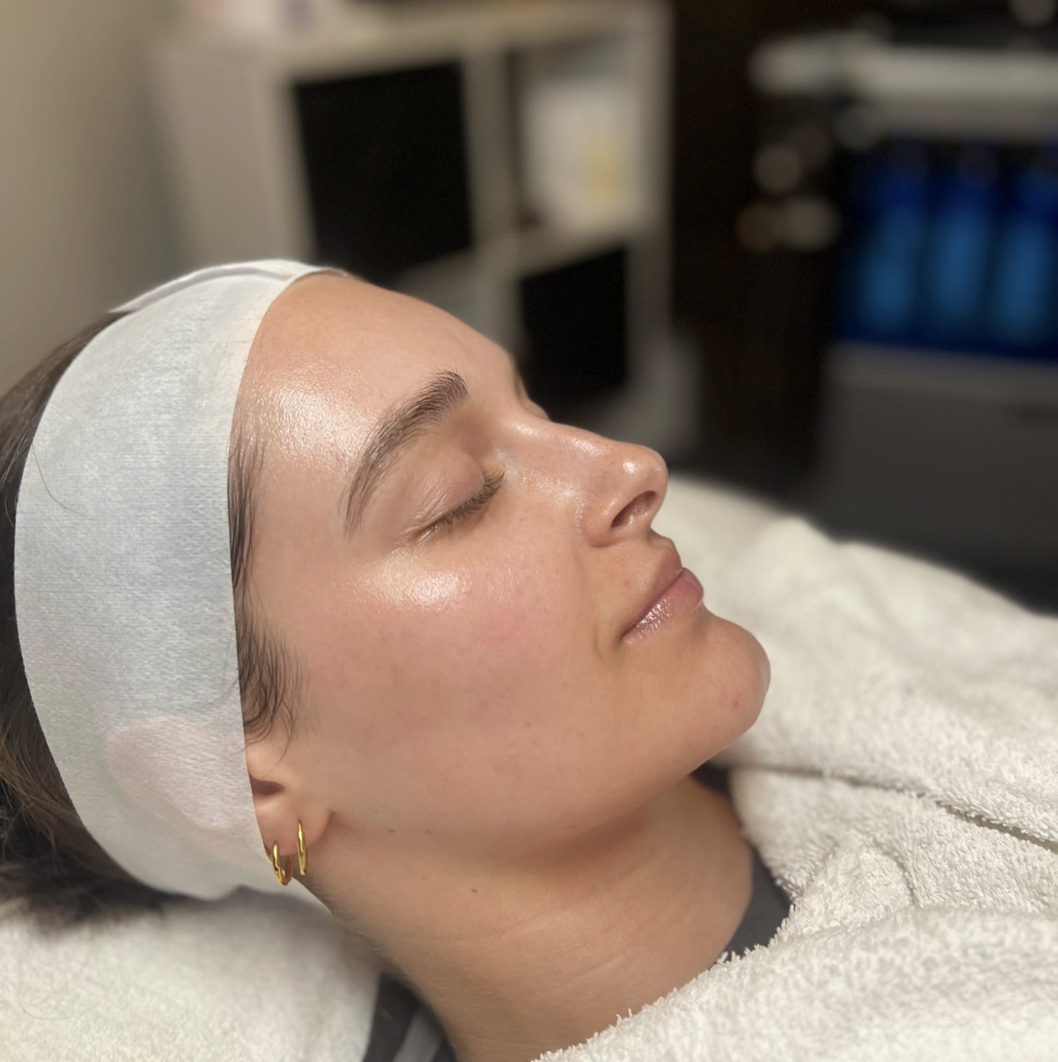 Client relaxing with a soothing mask during a Sunset Facial at Shine