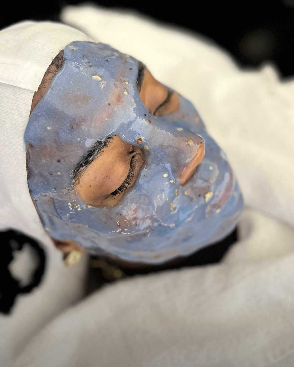 Matcha HydroJelly mask setting on a client's face during a facial at Shine