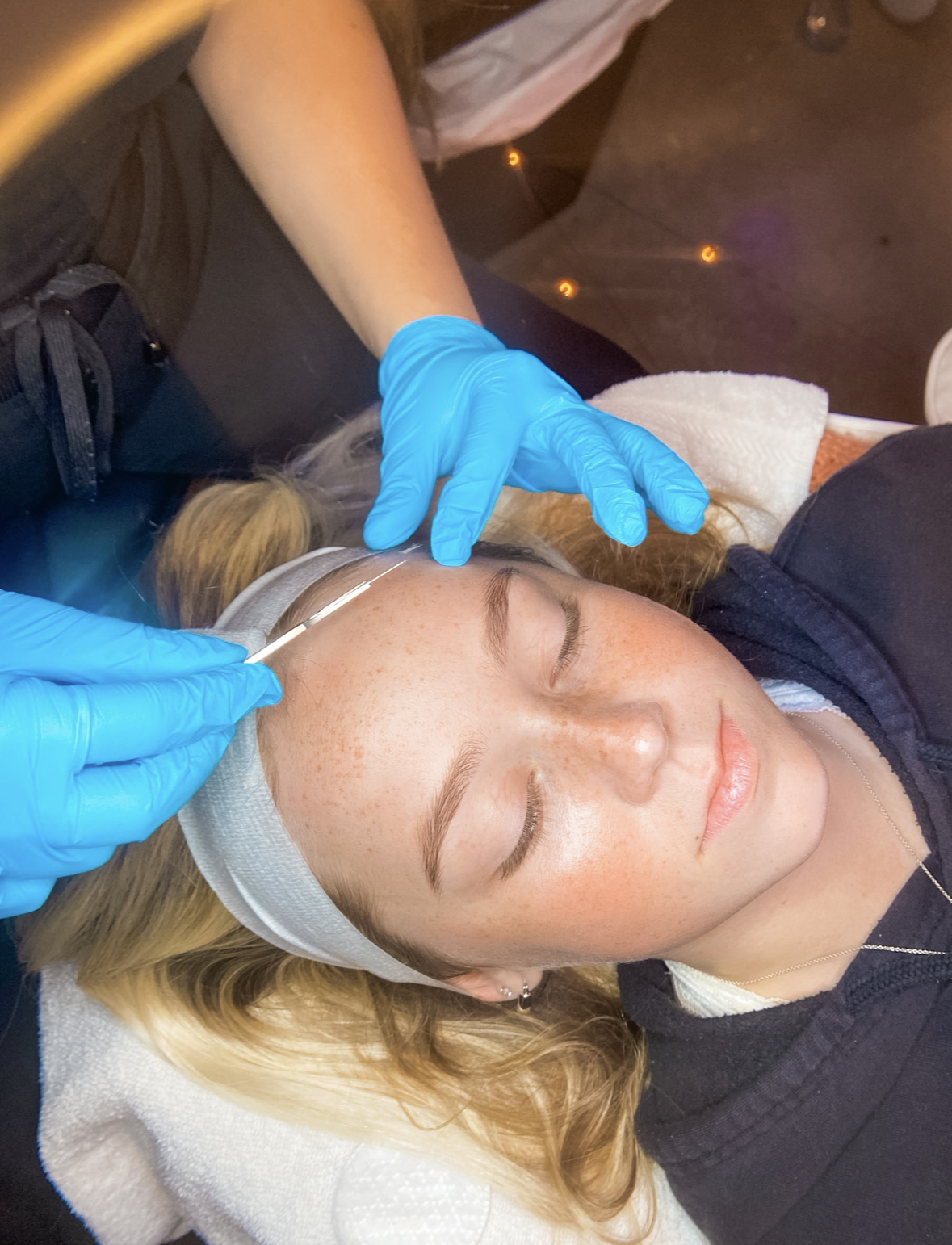 Esthetician performing a dermaplane treatment after a HydraFacial at Shine
